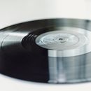Close-up of a spinning vinyl record on a turntable, capturing the nostalgic essence of analog music.